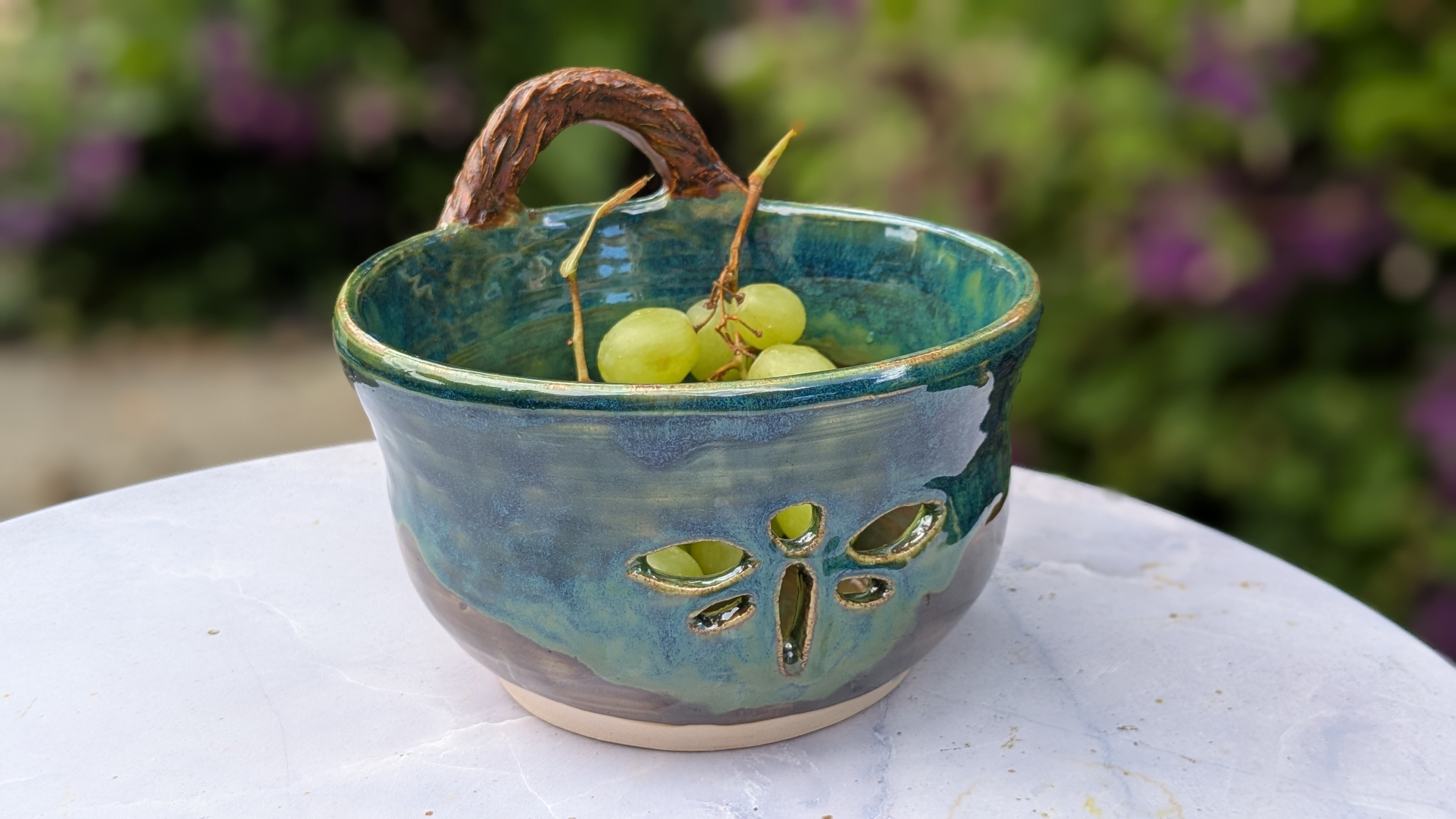 Rainforest Colander / Berry Bowl - One of my new favorite color combinations - it's hard to capture with a camera, just how bright and vivid these greens and blues are! Hand-thrown on the wheel and then hand-carved with my spirit animal, the dragonfly. The handle has a woven-looking texture imprint, accented by more dragonflies at the connection points. This is a handy little bowl that you'll use frequently throughout the summer to clean fresh fruits and display them on your kitchen counter. - 45