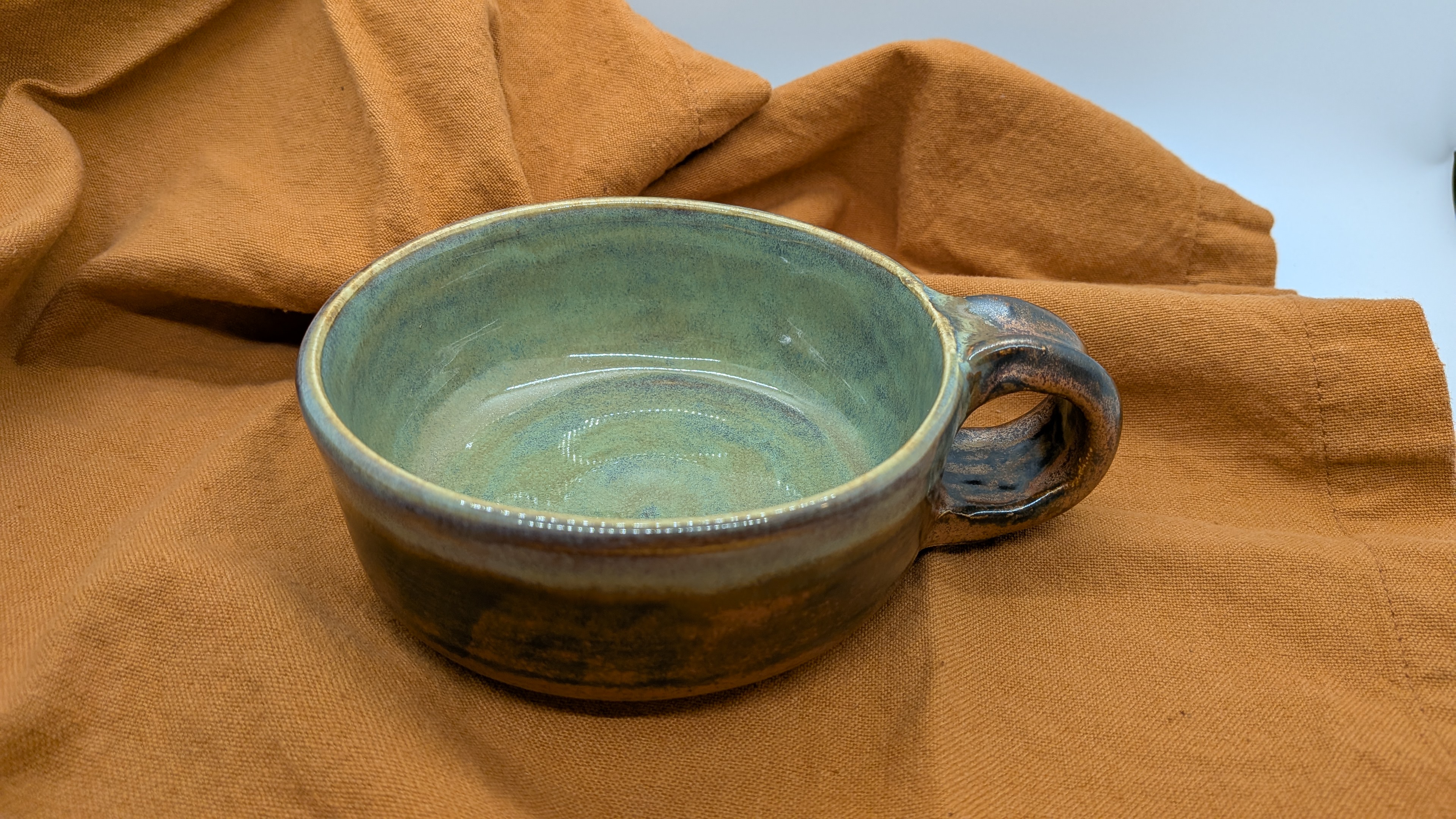 Teacup - Copper Turquoise Lustre - This cup has a lovely, earthy green color accented in copper on the exterior. Holds roughly 5-6 fluid oz. - 25